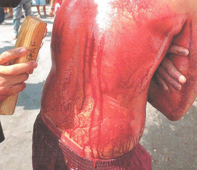 Catholic doing penance during Lent. His back is cut with glass and is covered with his own blood.